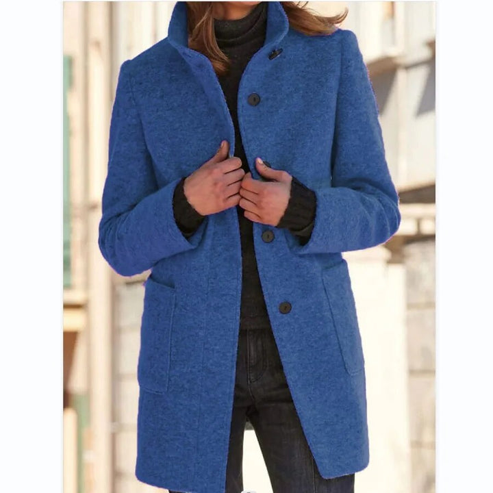 Blue longline wool-blend coat featuring a standing funnel collar, button-front closure, and practical front pockets.