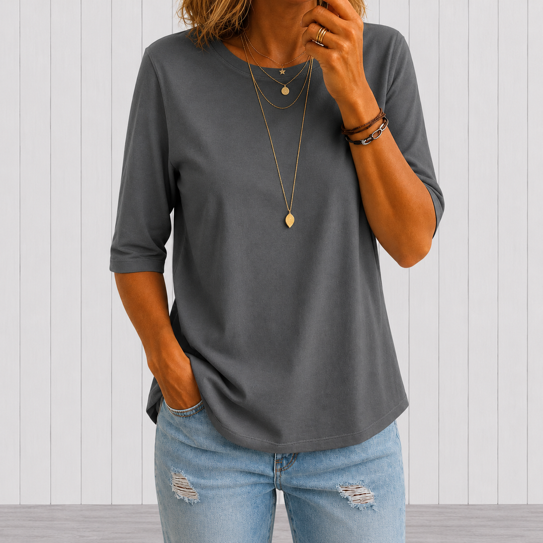 Charcoal grey round-neck top with half sleeves and a relaxed fit, styled with light wash distressed jeans.