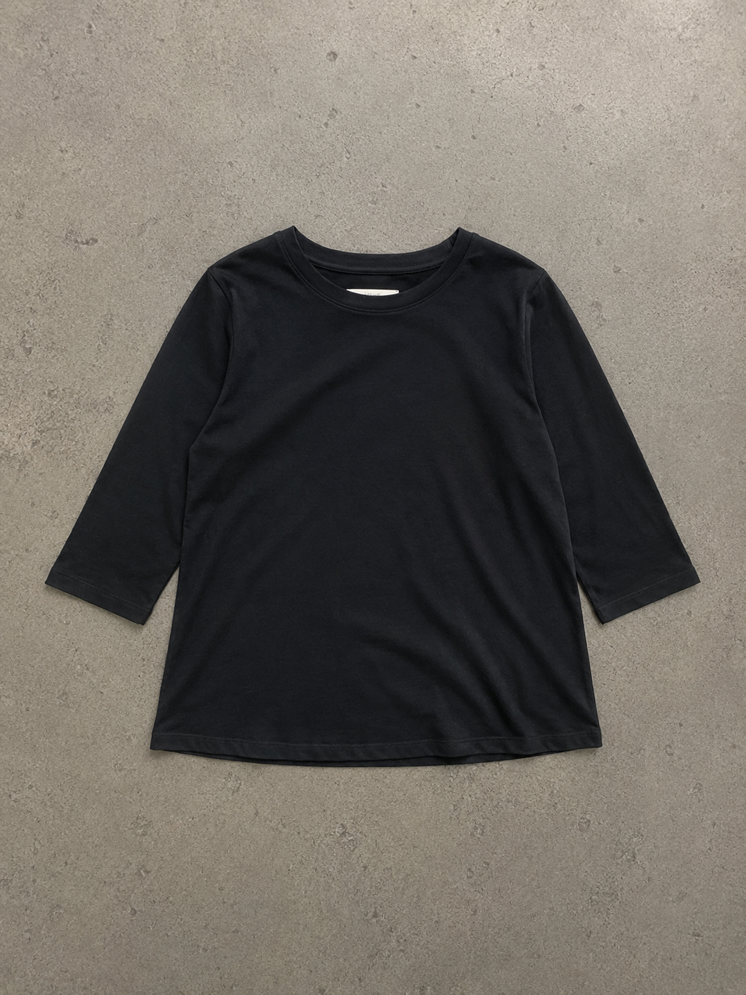 Black Daisy women's round-neck top with half sleeves and a relaxed fit, laid flat on a neutral surface.