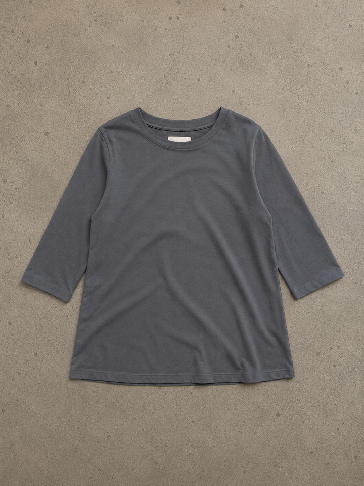 Charcoal grey women's round neck top with half sleeves and a relaxed, curved hem in soft, lightweight fabric.