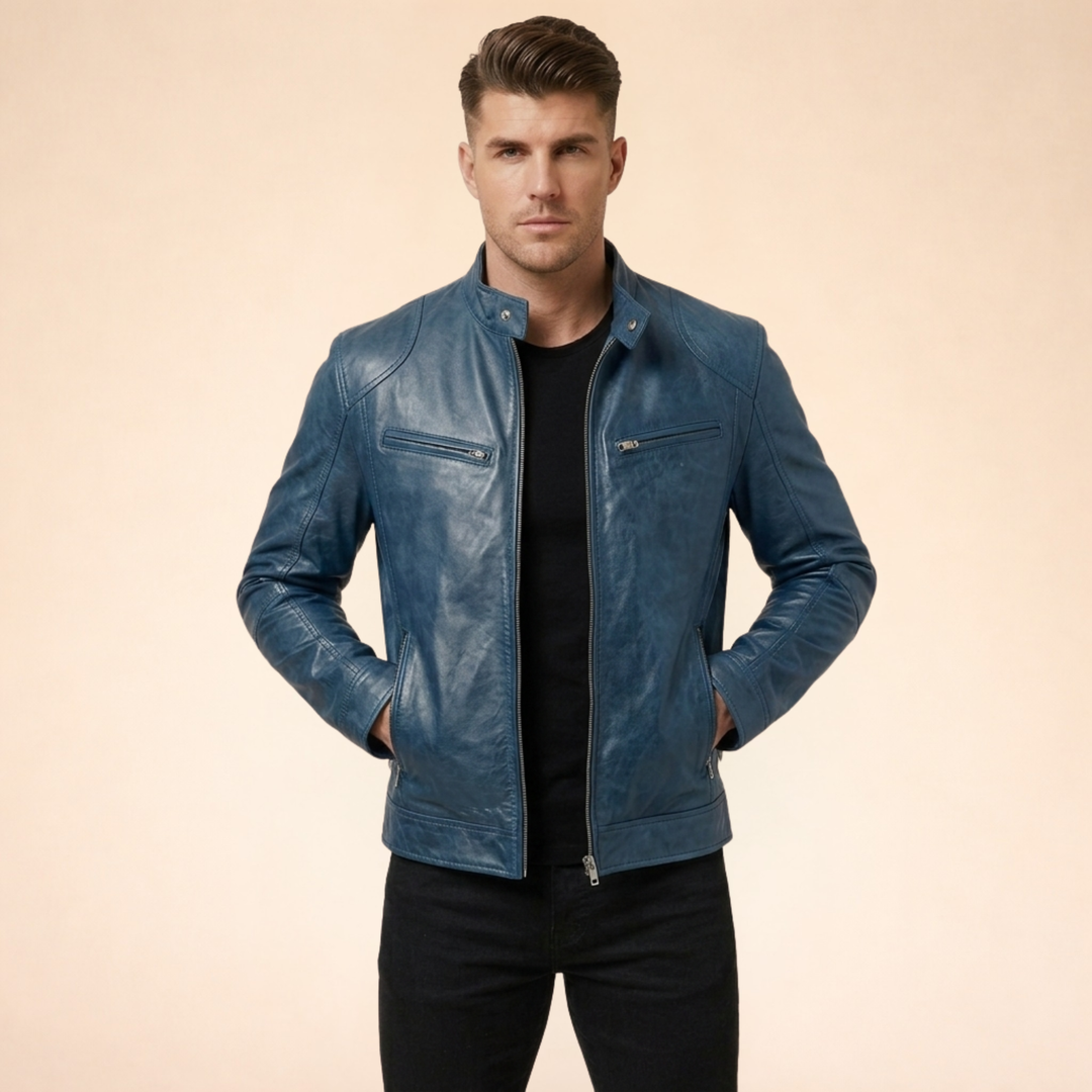 Blue slim-fit faux leather moto jacket with a band collar, snap tabs, and zip-front pockets for a sharp, modern look.