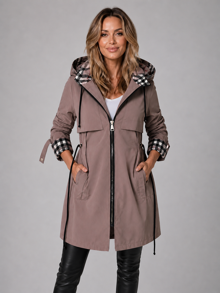Taupe longline hooded coat with a drawstring waist, full zip closure, and stylish contrast check-lined hood and cuffs.