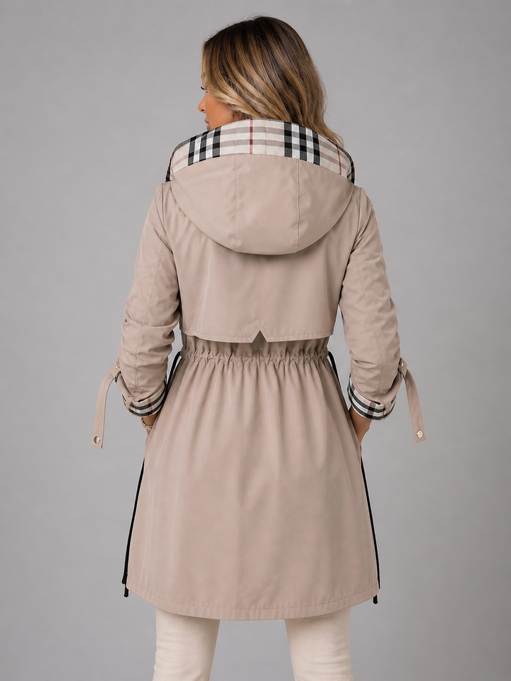 Beige longline hooded coat featuring a drawstring waist, check-lined hood, and roll-up cuffs for a refined, modern fit.