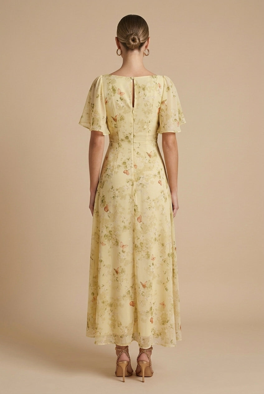 Delilah women's floral square neck maxi dress in soft yellow with flutter sleeves and a flowing A-line skirt.