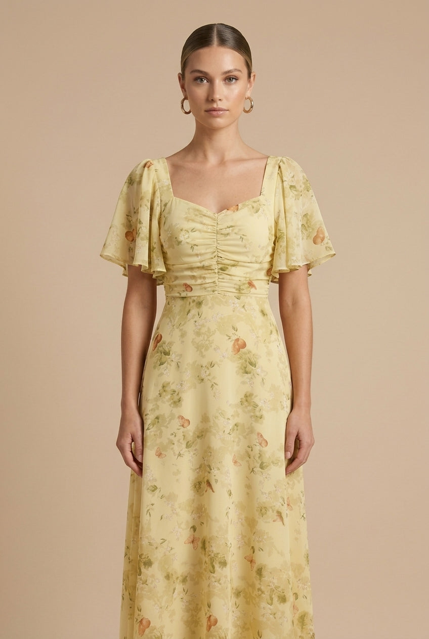 Delilah women's floral square neck maxi dress in soft yellow with flutter sleeves and ruched bodice.