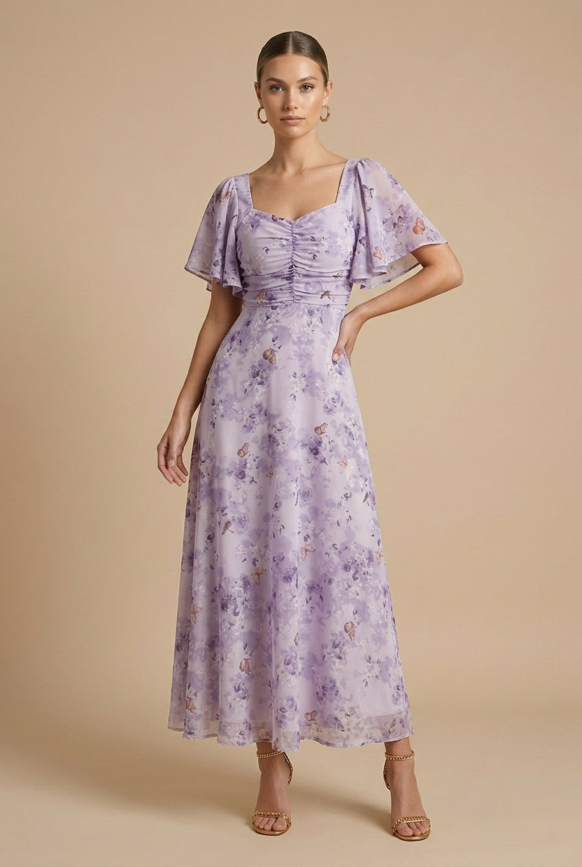 Delilah women's floral square neck maxi dress in soft lavender with ruched bodice and flutter sleeves.