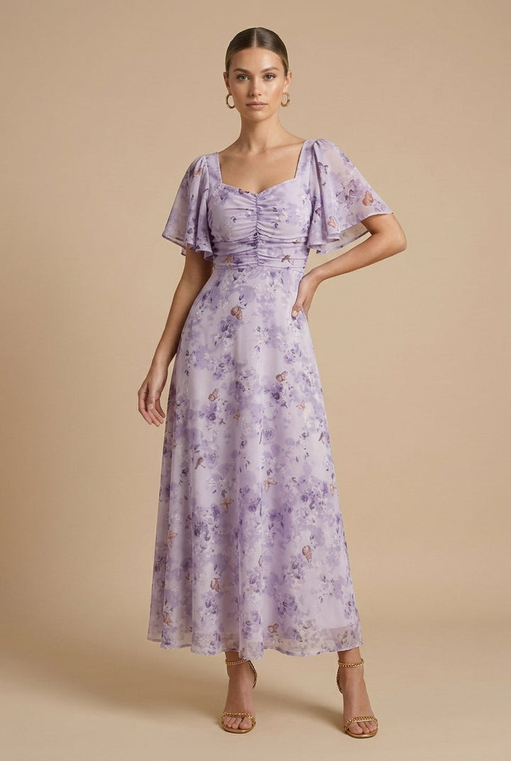Delilah women's floral square neck maxi dress in soft lavender with ruched bodice and flutter sleeves.