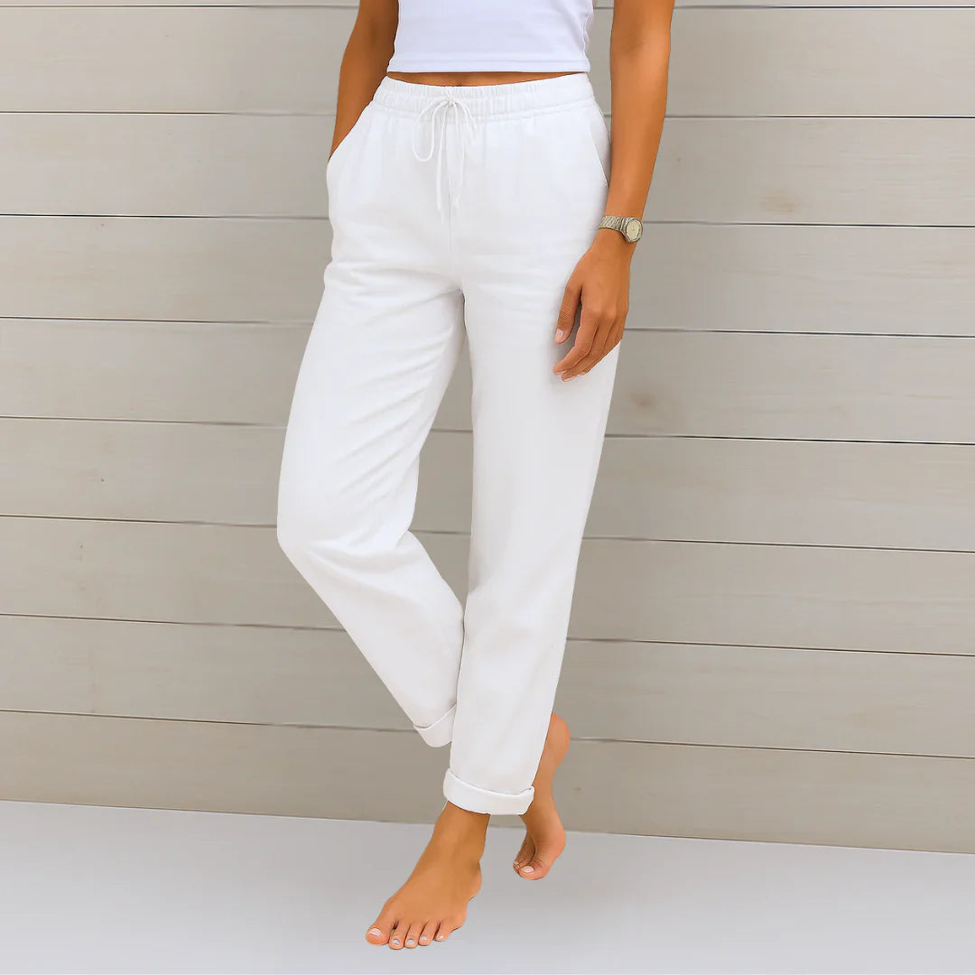 Delilah women's high-waisted relaxed white trousers with an elastic waistband and drawstring, cuffed at the ankle.