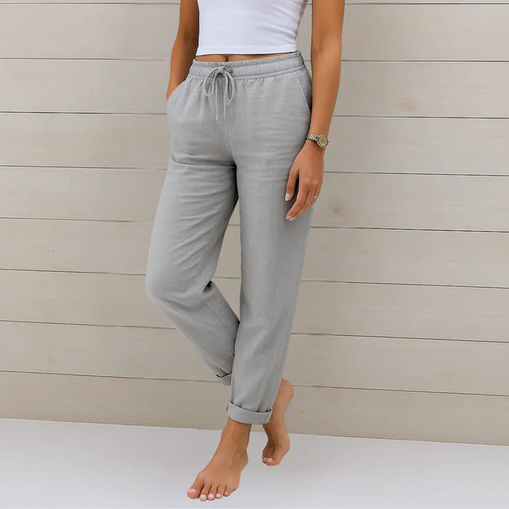 Delilah women's high-waisted relaxed grey trousers with an elastic drawstring waist and cuffed ankles.