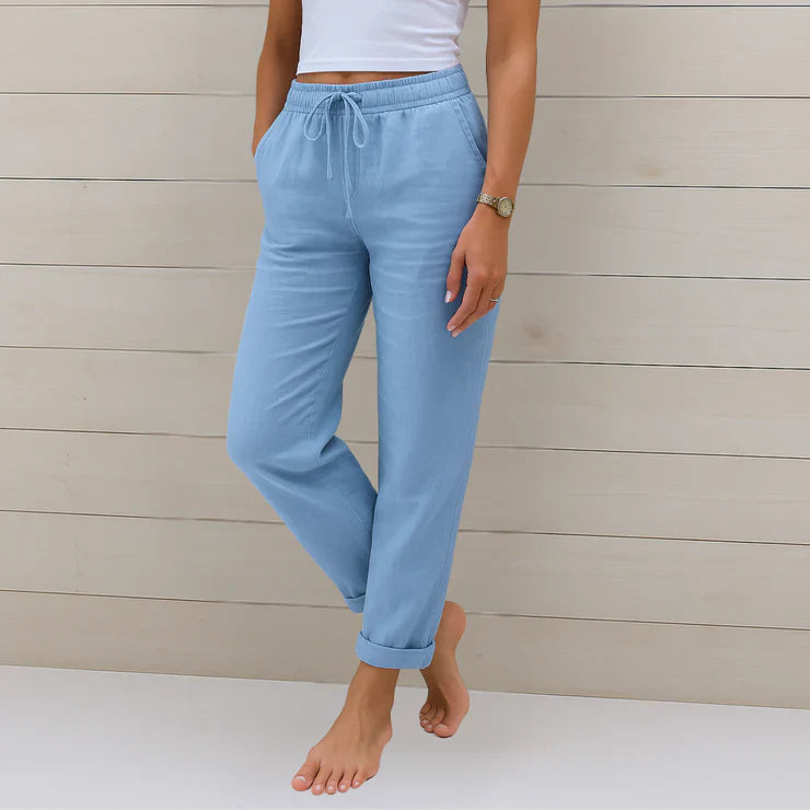 Delilah women's high-waisted relaxed trousers in light blue with an elastic drawstring waist and rolled cuffs.