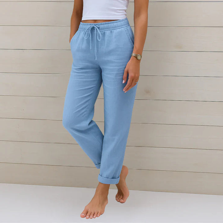 Delilah women's high-waisted relaxed trousers in light blue with an elastic drawstring waist and rolled cuffs.