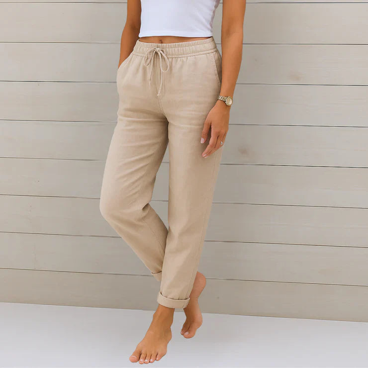 Delilah women's high-waisted relaxed trousers in a neutral tone with an elastic drawstring waist and cuffed ankles.