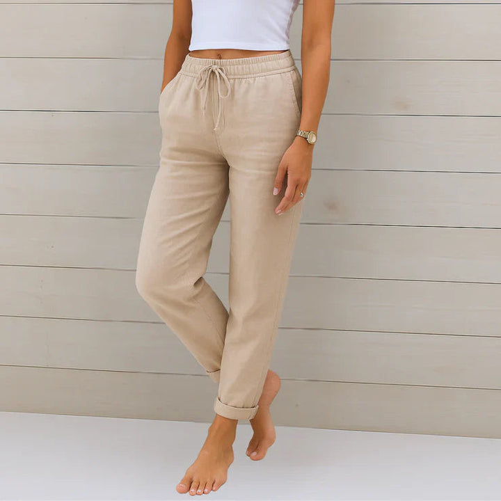 Delilah women's high-waisted relaxed trousers in a neutral tone with an elastic drawstring waist and cuffed ankles.