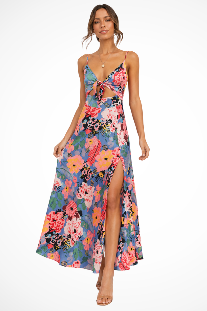 Blue floral maxi dress with a tie-front bodice, waist cut-out, adjustable straps, and a high side slit.