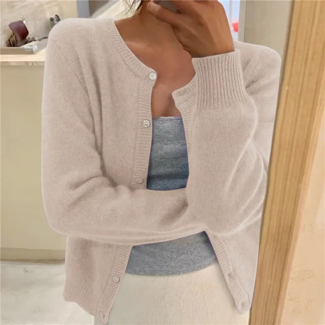 Beige soft knit crew neck cardigan with long sleeves, ribbed cuffs, and a button-front closure.