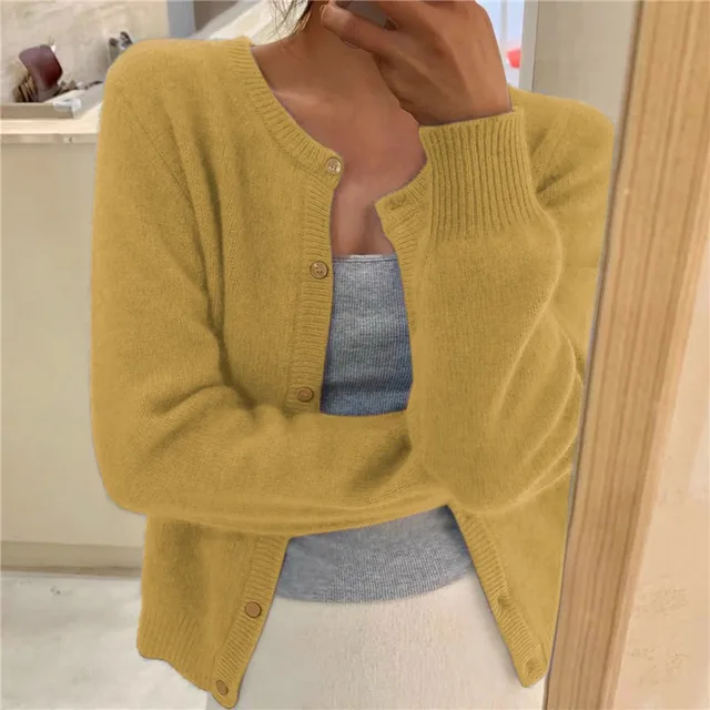 Mustard yellow knit crew neck cardigan with long sleeves, ribbed cuffs, and a button-front closure.