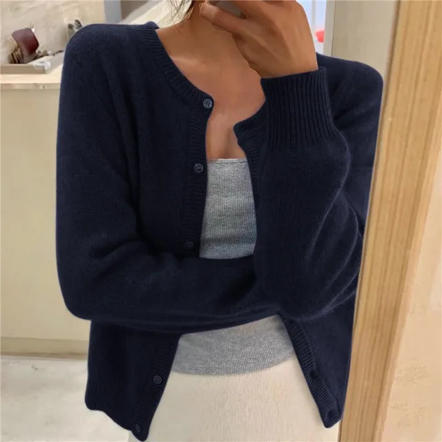 Navy blue knit crew neck cardigan with long sleeves, ribbed cuffs, and a button-through front.