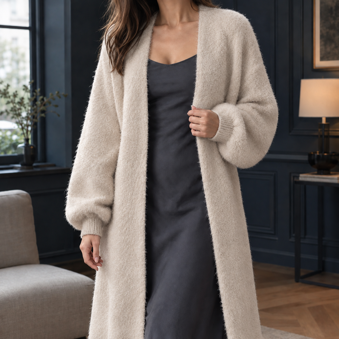 Beige longline open-front cardigan in a soft, fluffy knit with ribbed cuffs, layered over a charcoal slip dress.