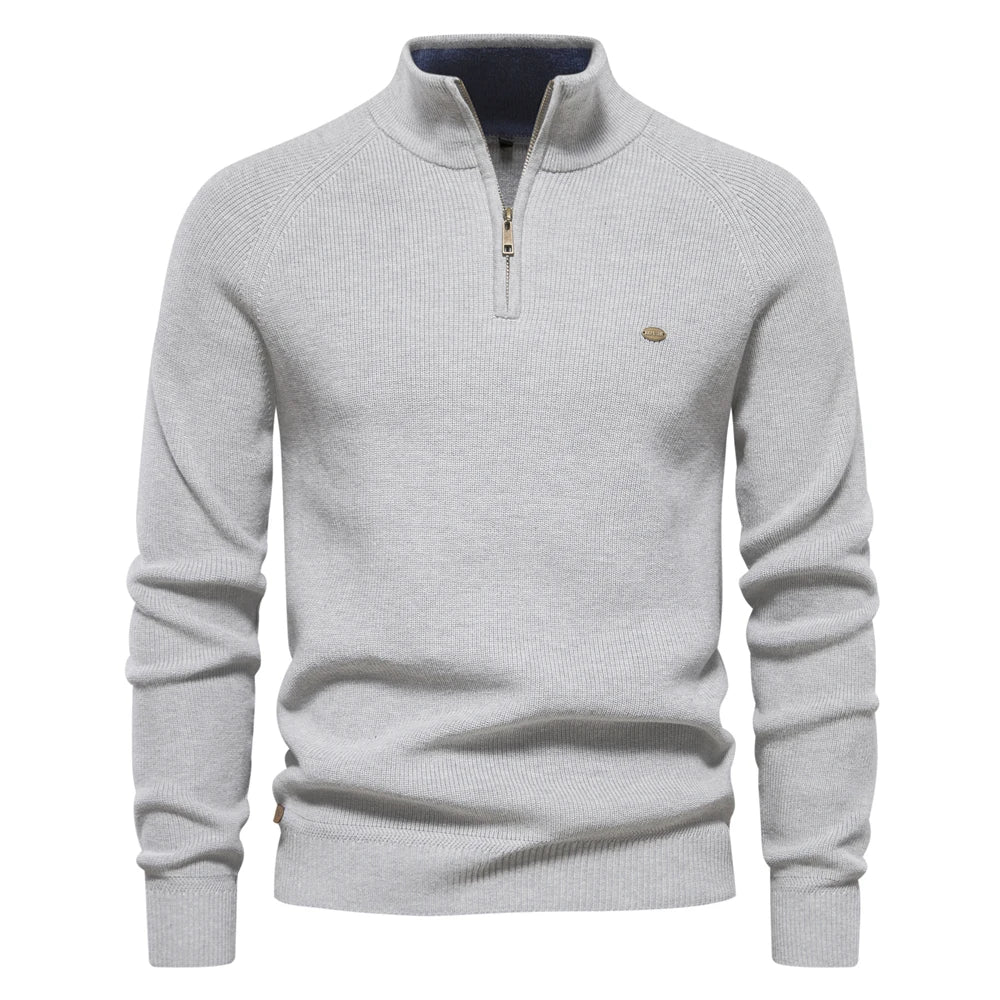 Light grey men's quarter-zip knit sweater with ribbed cuffs, hem, and a small metal logo detail on the chest.