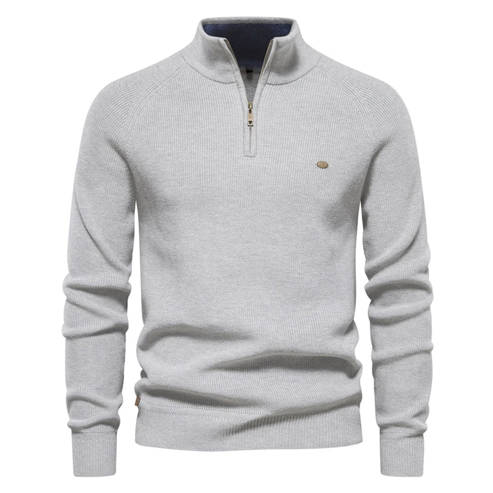 Light grey men's quarter-zip knit sweater with ribbed cuffs, hem, and a small metal logo detail on the chest.