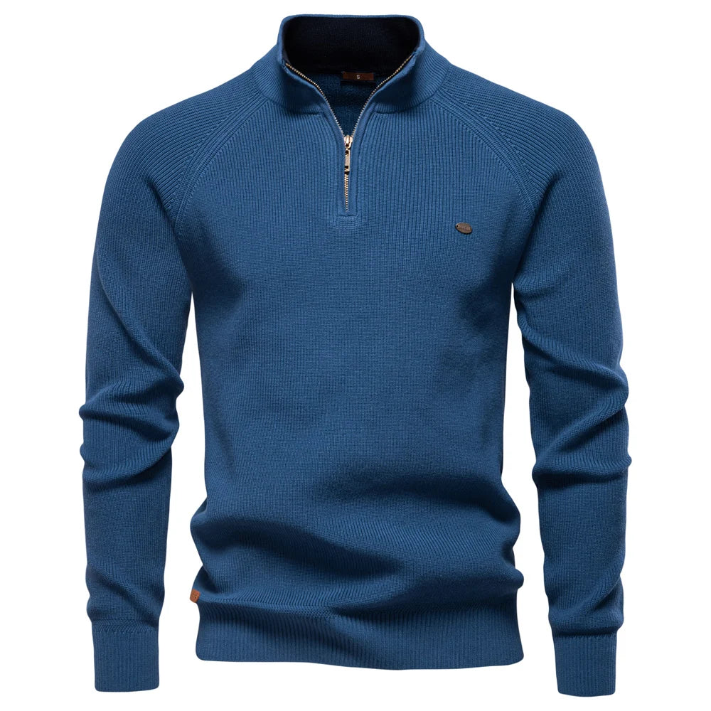 Blue men's quarter-zip knit sweater with ribbed texture, long sleeves, and a tailored fit.