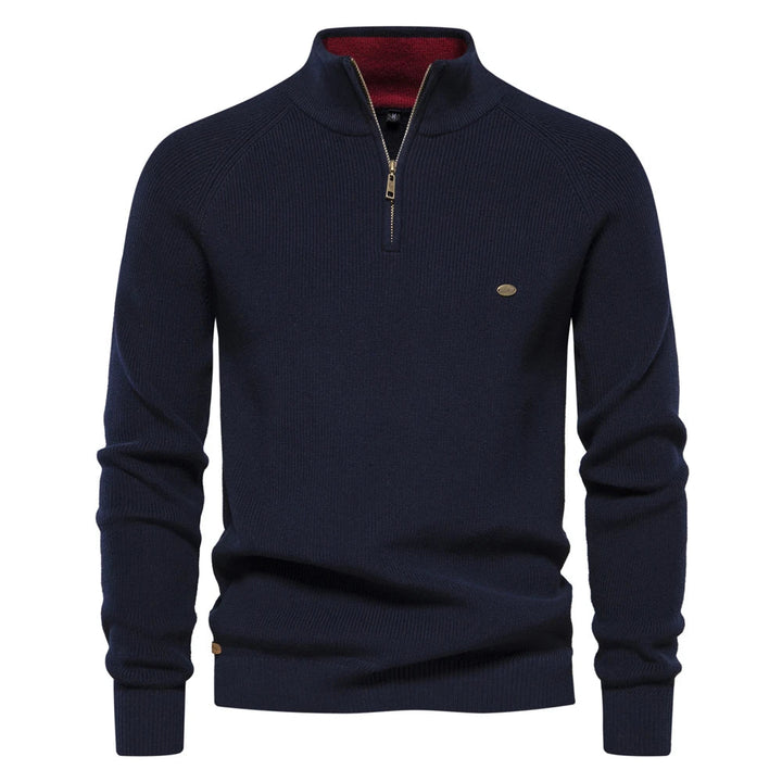 Navy blue men's quarter-zip knit sweater with a contrasting red inner collar and ribbed cuffs.
