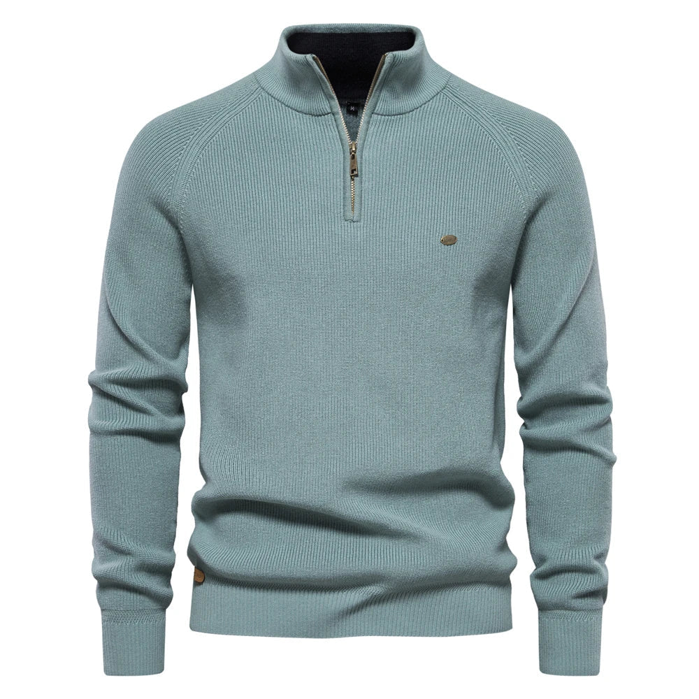 Sage green men's quarter-zip knit sweater with ribbed texture, stand collar, and metallic zipper detail.