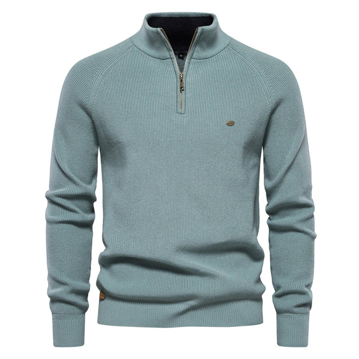 Sage green men's quarter-zip knit sweater with ribbed texture, stand collar, and metallic zipper detail.
