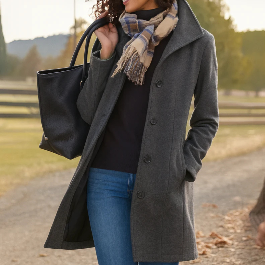 Charcoal grey mid-length button-up winter coat with a structured collar, side pockets, and a tailored fit.
