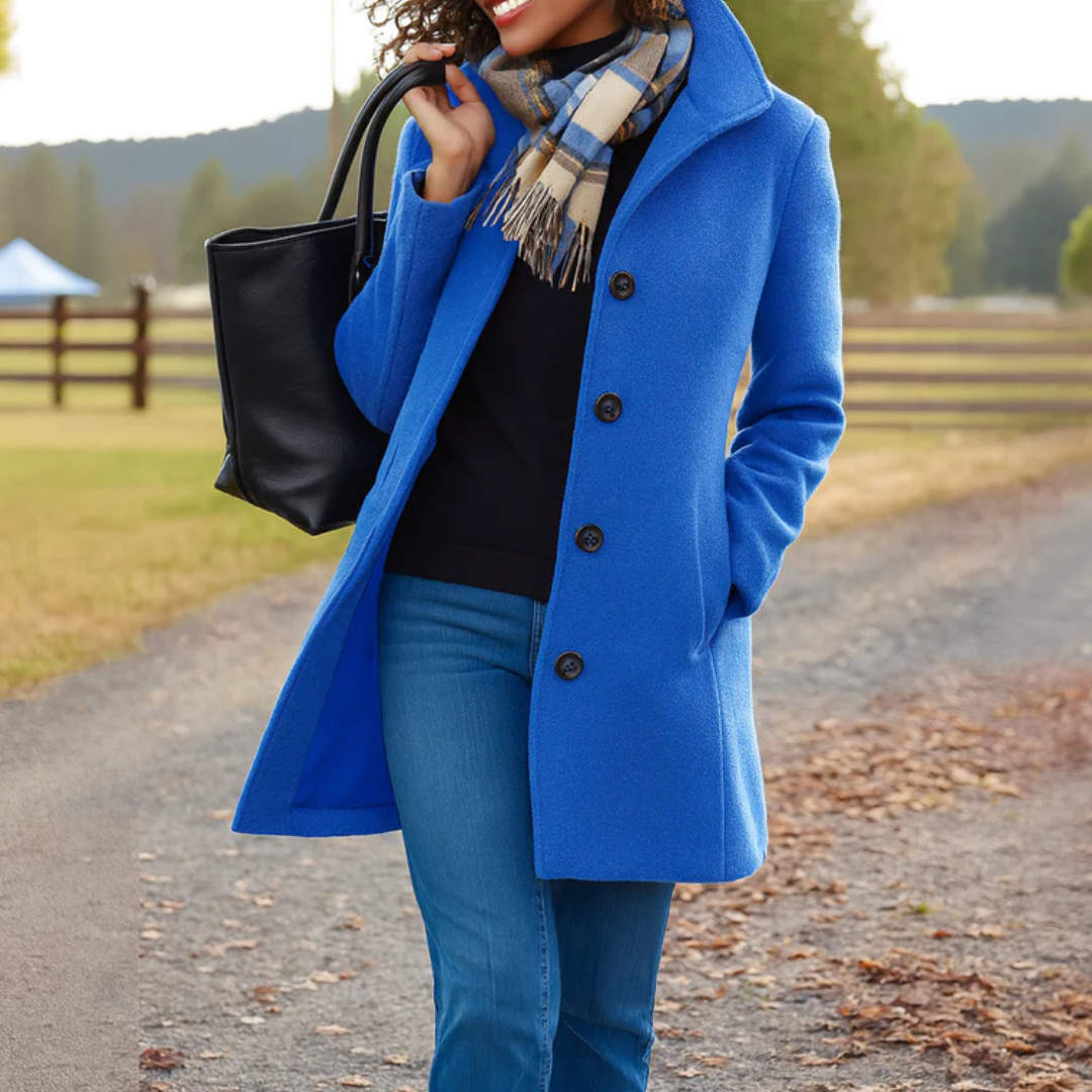 Woman wearing a vibrant blue single-breasted mid-length wool coat with a turn-down collar, buttons, and side pockets.
