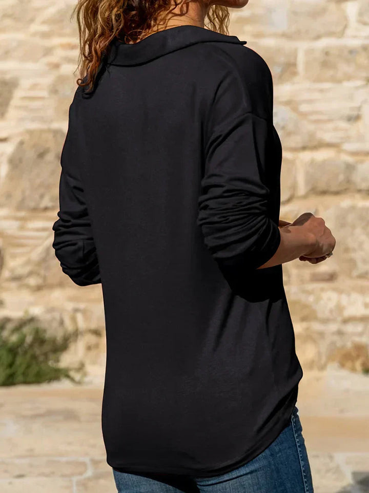 Back view of a black long-sleeve half-zip sweatshirt with a collared neckline and relaxed straight fit.