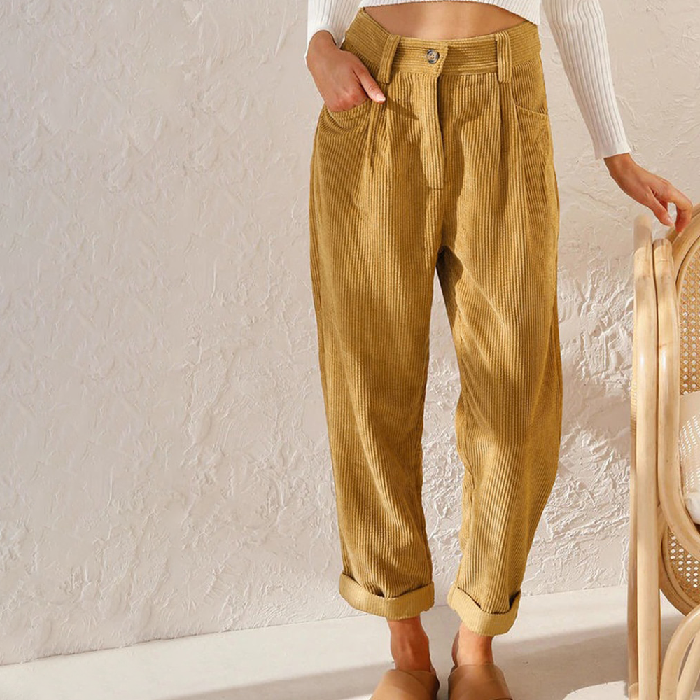 Mustard yellow high-waisted corduroy trousers with a relaxed fit, button front, and cuffed hems.