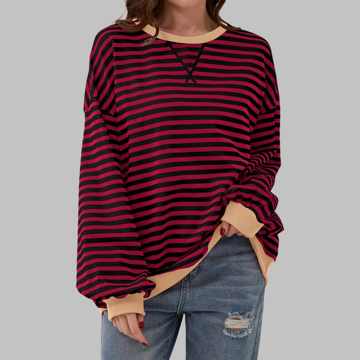 Oversized red and black striped sweatshirt with a contrast beige crew neckline and ribbed cuffs.