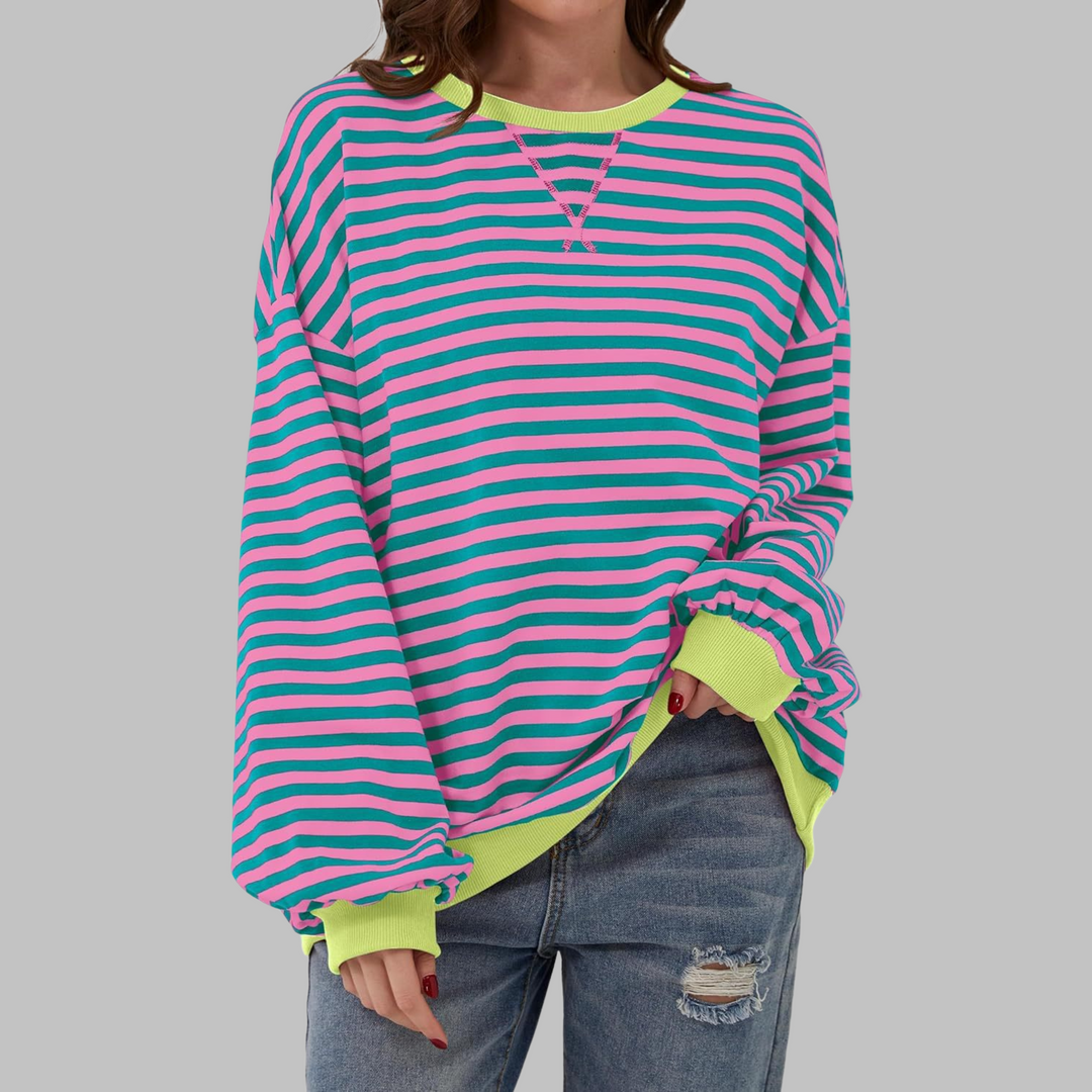 Oversized sweatshirt with pink and teal horizontal stripes, neon yellow ribbed trim, and a relaxed round neckline.