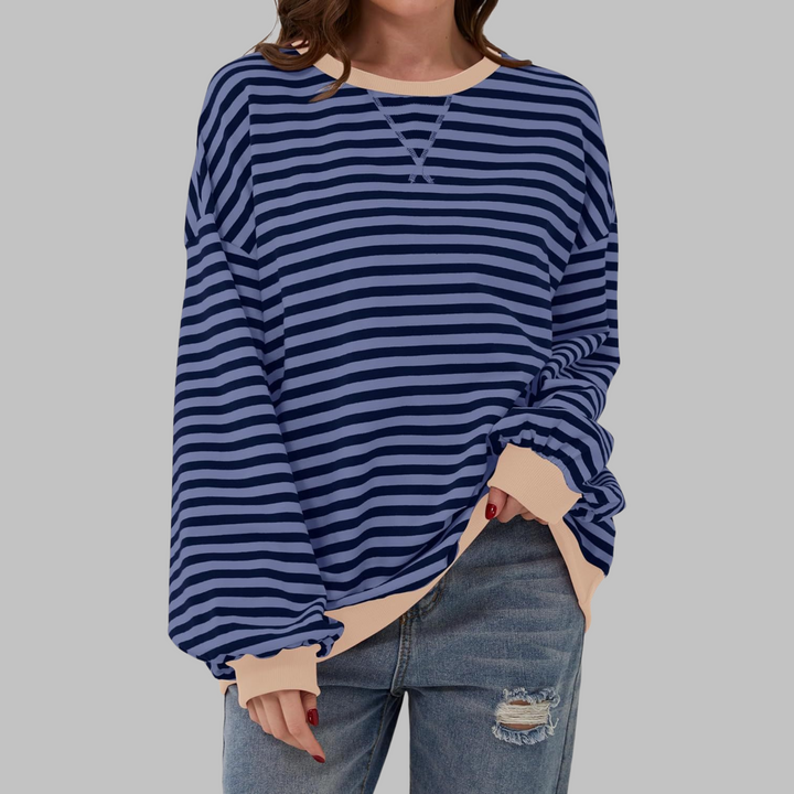 Oversized navy and light blue striped sweatshirt with contrast beige ribbed neckline and cuffs.