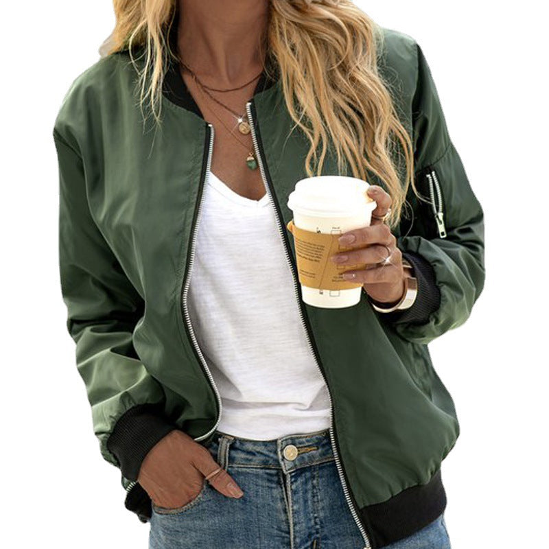Olive green women's bomber jacket with front zip, black ribbed cuffs, and utility sleeve pocket over a white tee.