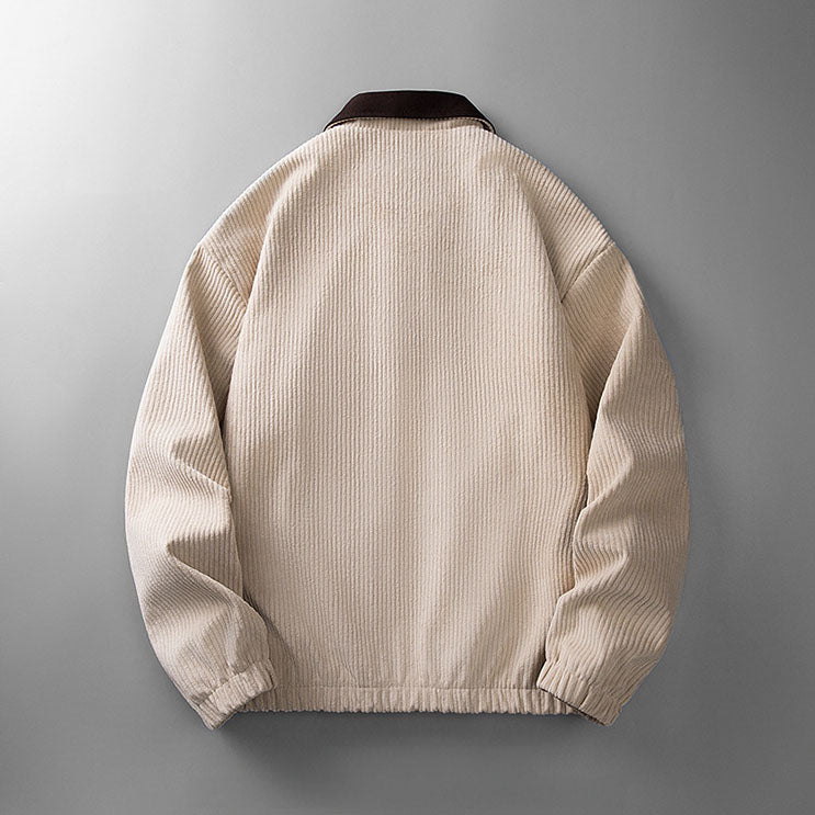 Back view of a beige corduroy zip-up jacket with a dark brown collar and elasticated hem on a grey background.