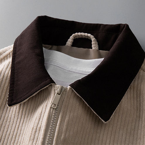 Beige corduroy zip-up jacket featuring a contrasting dark brown collar and full-length front zipper.