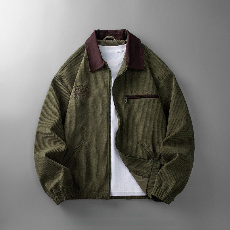Olive green corduroy zip-up jacket with a contrasting dark collar, chest pocket, and relaxed fit over a white t-shirt.