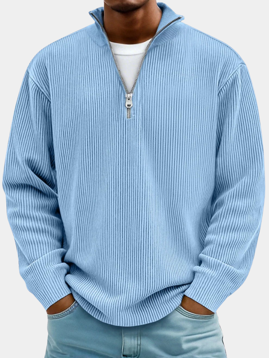 Light blue men's ribbed half-zip sweater with a stand collar, worn over a white t-shirt.