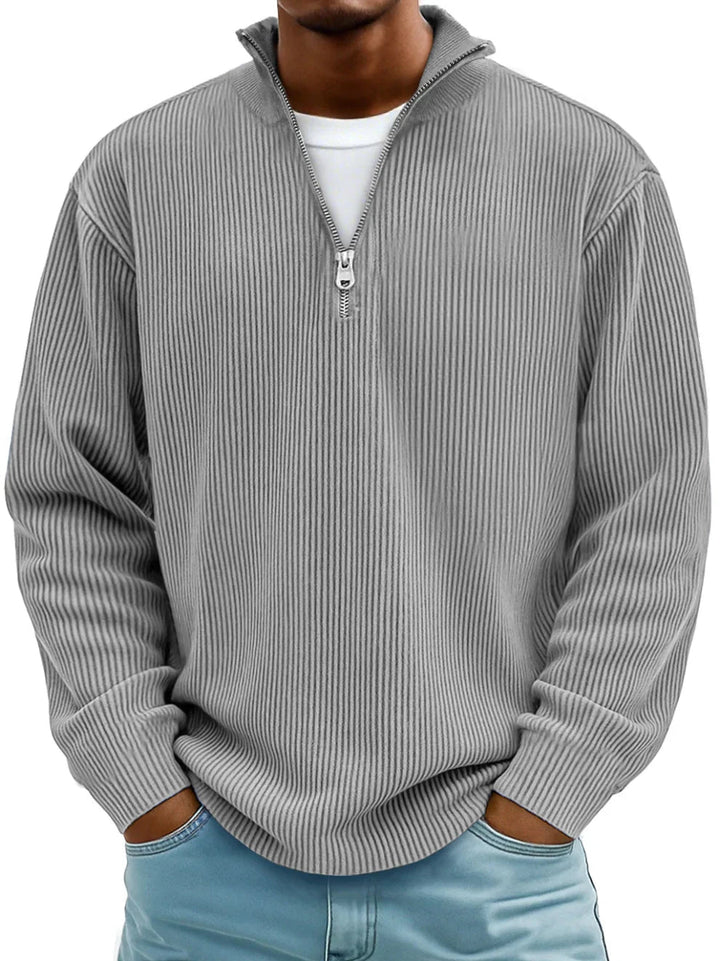 Grey men's ribbed half-zip sweater with a stand collar and relaxed fit, worn over a white t-shirt.