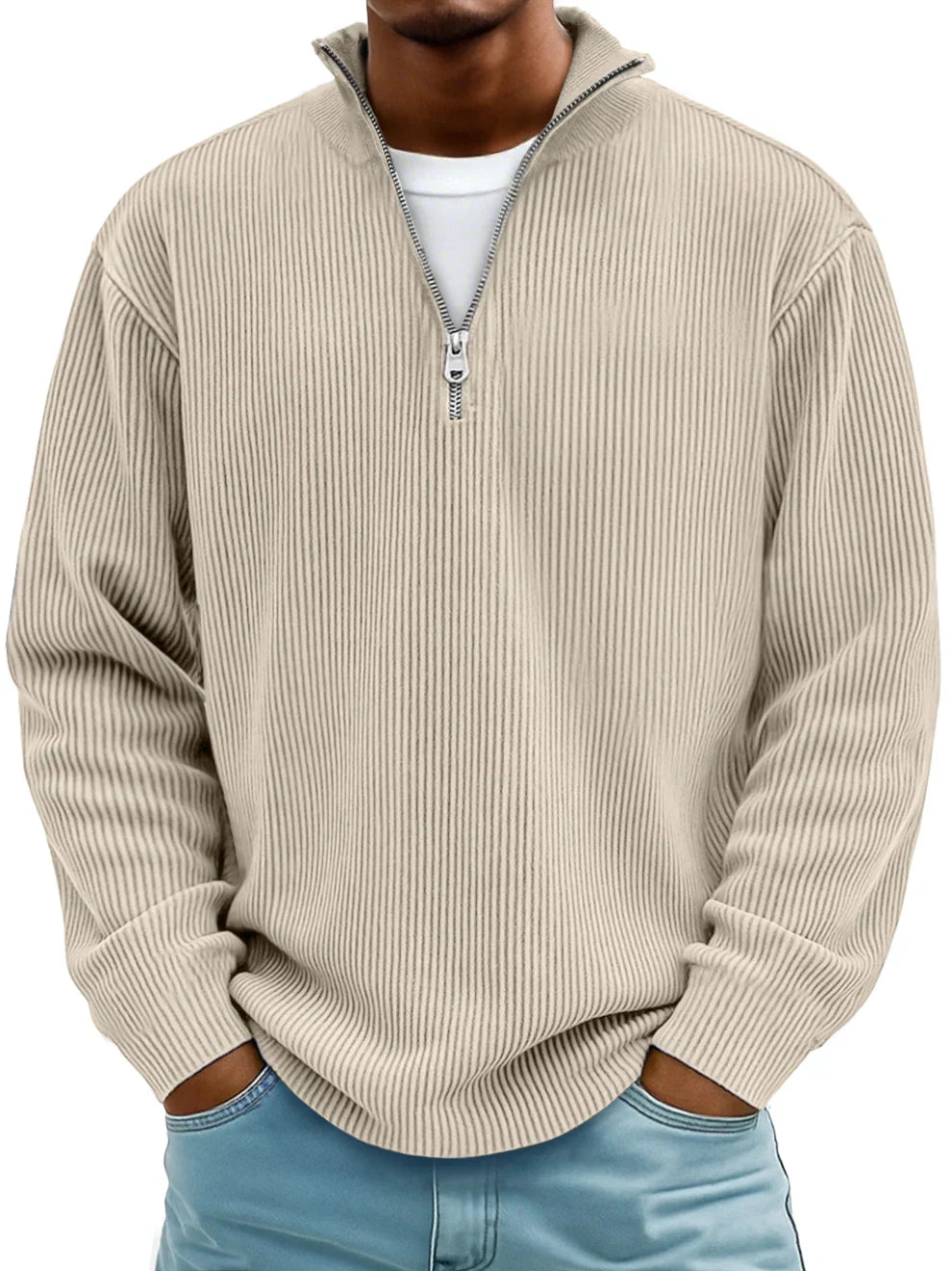 Beige men's ribbed half-zip sweater with a stand collar and relaxed fit, worn over a white shirt and blue jeans.