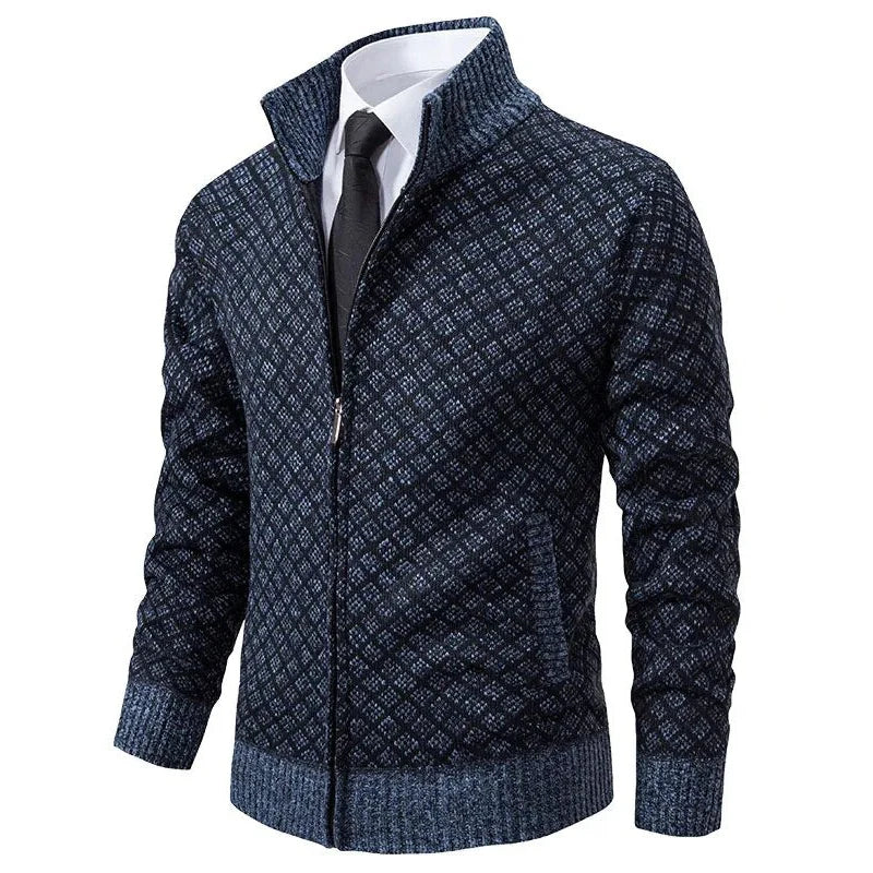Navy blue diamond-textured knit zip-up cardigan with a stand collar and ribbed hem worn over a white shirt and tie.