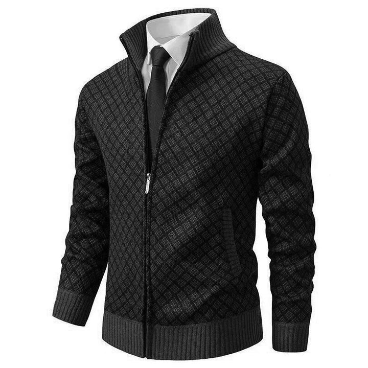 Black diamond-textured knit zip-up cardigan with a stand collar, ribbed cuffs, and hem worn over a shirt and tie.