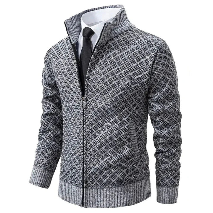 Grey diamond-textured knit zip-up cardigan with a stand collar and ribbed cuffs worn over a white shirt and tie.