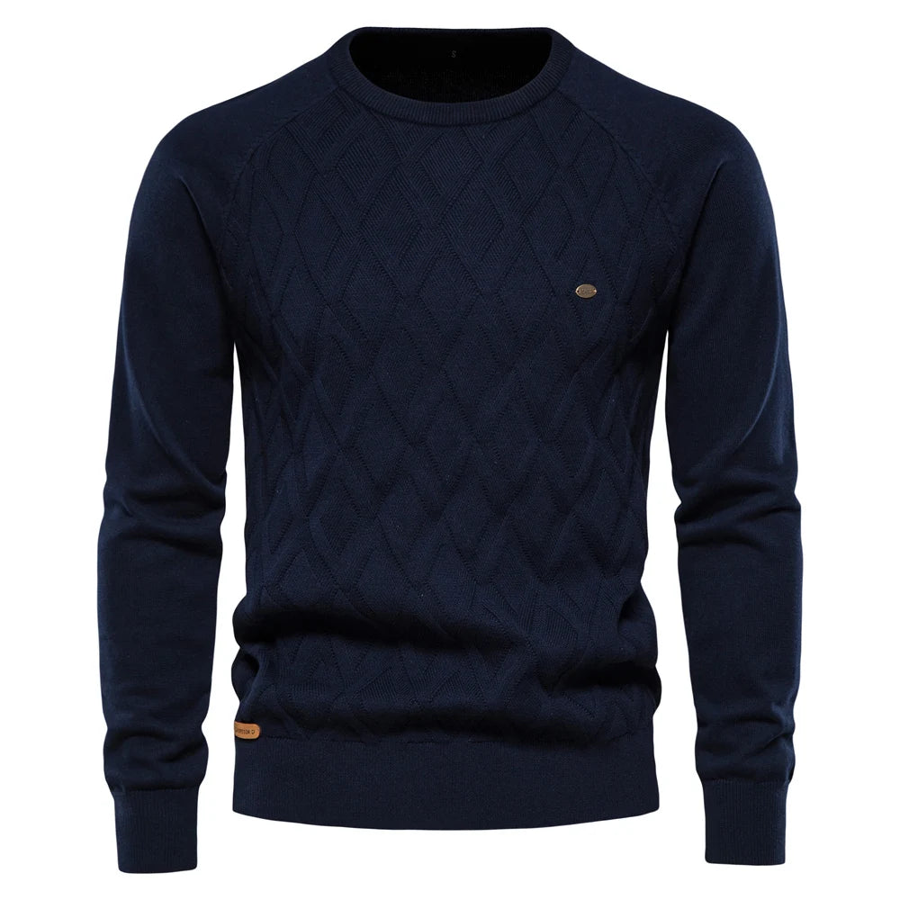 Navy blue men's crew neck jumper featuring a textured diamond-knit pattern, ribbed cuffs, and a small chest logo detail.