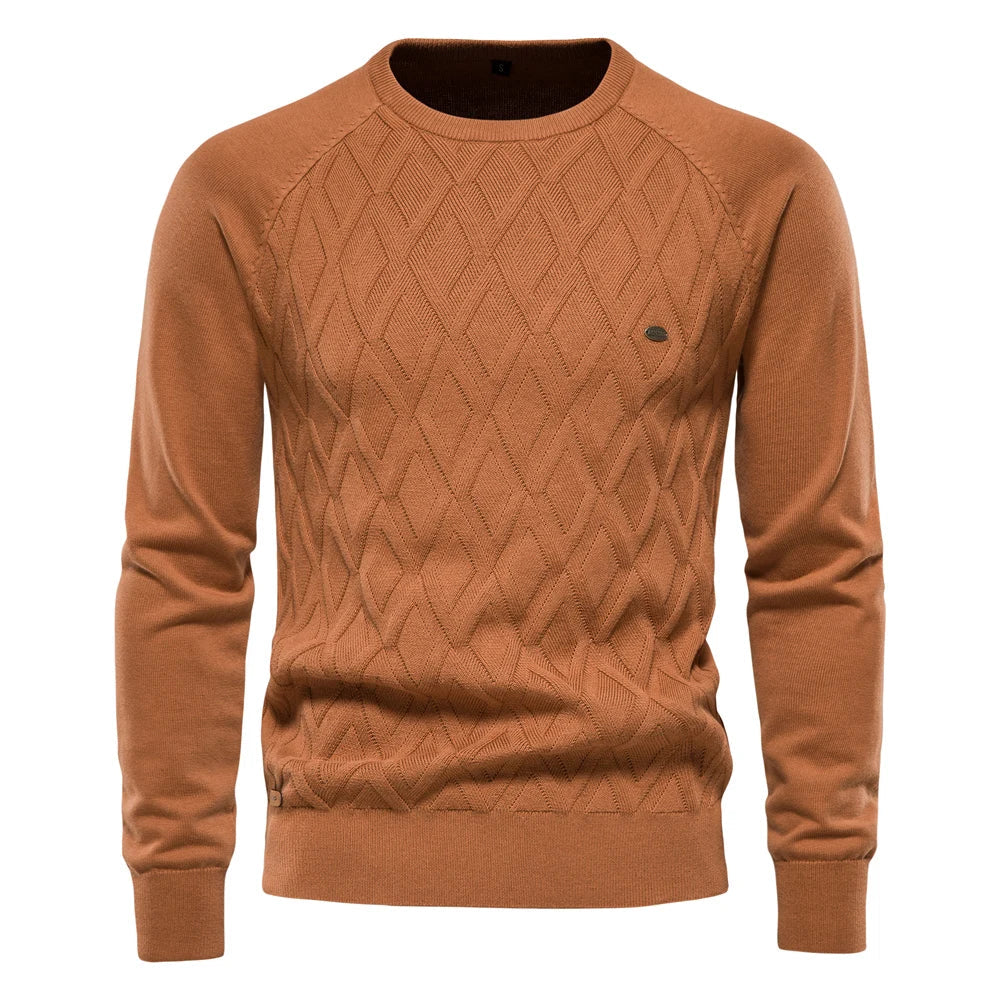 Men's rust-colored crew neck jumper featuring a textured diamond-knit pattern, raglan sleeves, and ribbed trim.