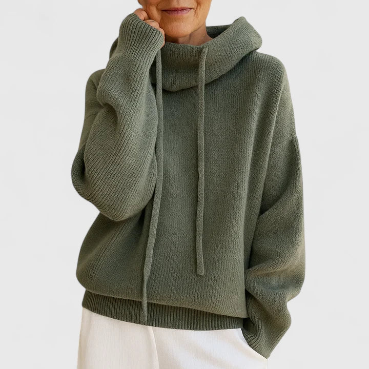Sage green oversized knit jumper featuring a slouchy cowl hood, drop shoulders, and ribbed cuffs.