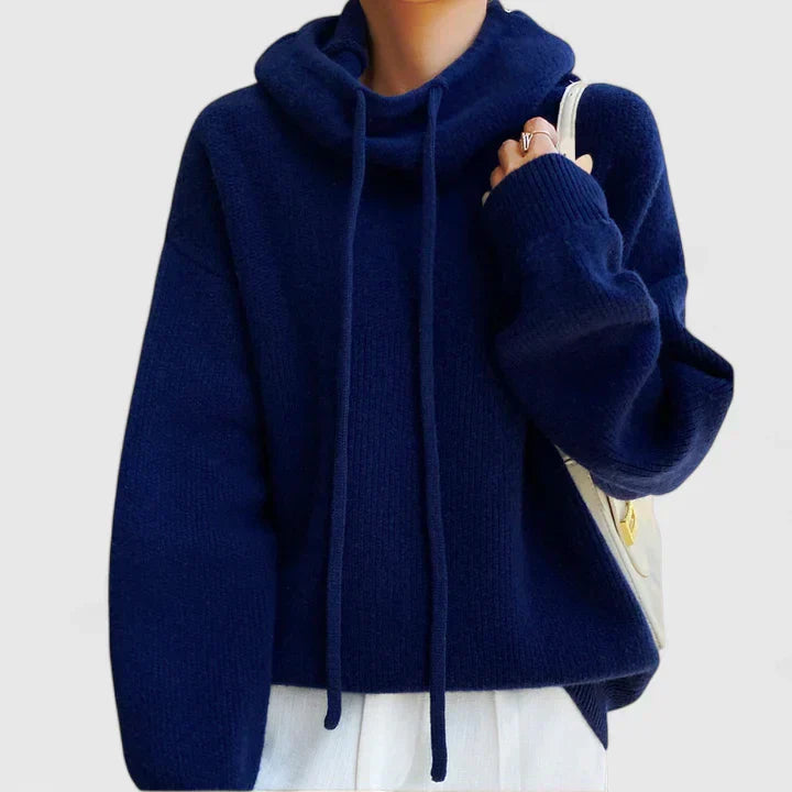 Navy blue oversized knit jumper with a slouchy cowl hood, drop shoulders, and ribbed cuffs.