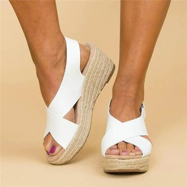 Women's white leather orthopedic espadrille wedge sandals with adjustable cross straps and jute-wrapped heel.